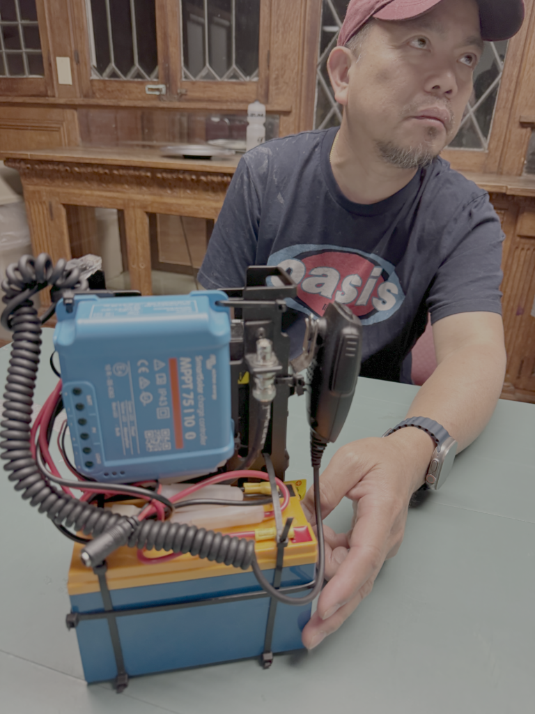 Efren Batayloa, KN6YYN demonstrates his mobile radio setup.